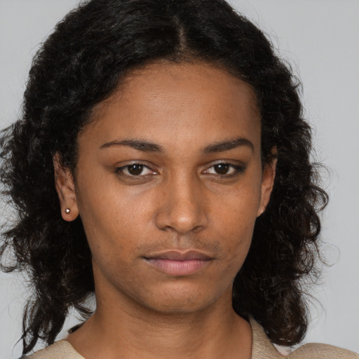 Neutral black young-adult female with medium  brown hair and brown eyes