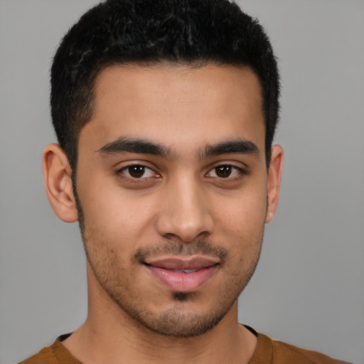 Joyful latino young-adult male with short  brown hair and brown eyes