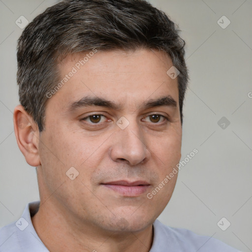 Joyful white adult male with short  brown hair and brown eyes