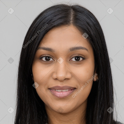 Joyful black young-adult female with long  black hair and brown eyes