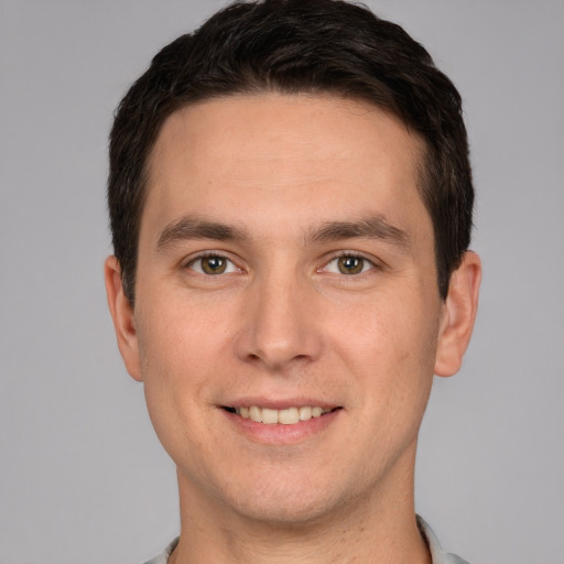 Joyful white young-adult male with short  brown hair and brown eyes