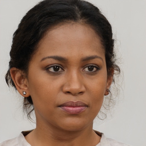 Joyful black young-adult female with medium  brown hair and brown eyes