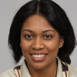 Joyful black young-adult female with medium  brown hair and brown eyes