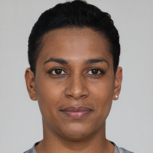 Joyful black young-adult female with short  black hair and brown eyes