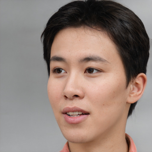 Joyful asian young-adult female with short  brown hair and brown eyes
