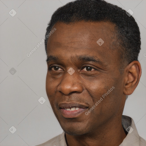 Joyful black adult male with short  black hair and brown eyes