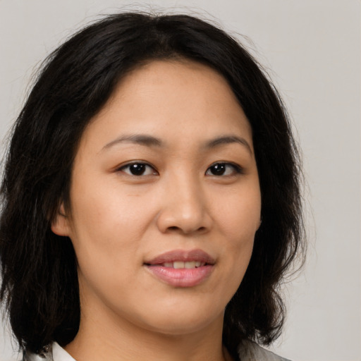 Joyful asian young-adult female with medium  brown hair and brown eyes