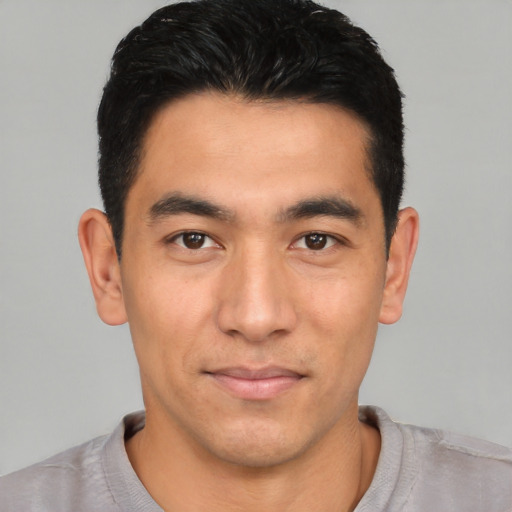 Joyful asian young-adult male with short  black hair and brown eyes