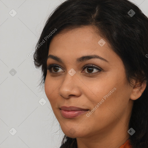 Joyful latino young-adult female with long  brown hair and brown eyes