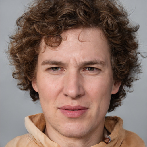 Joyful white adult male with medium  brown hair and grey eyes