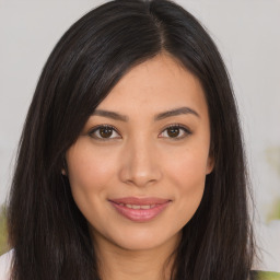 Joyful asian young-adult female with long  brown hair and brown eyes