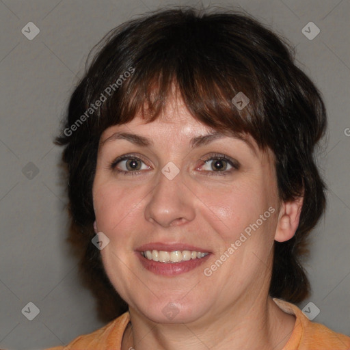 Joyful white adult female with medium  brown hair and brown eyes