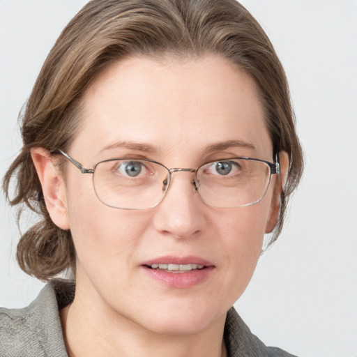 Joyful white adult female with medium  brown hair and blue eyes