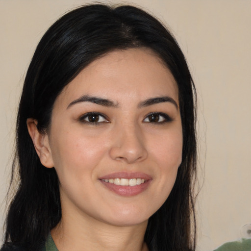 Joyful white young-adult female with long  black hair and brown eyes