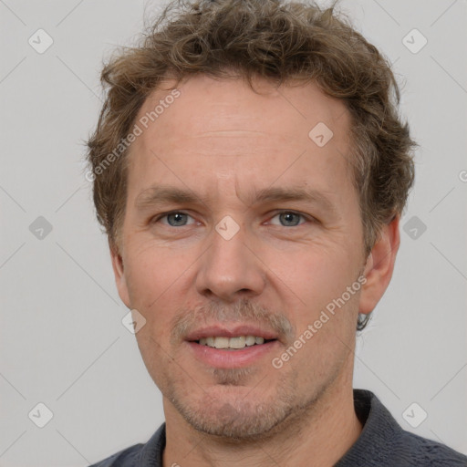 Joyful white adult male with short  brown hair and grey eyes