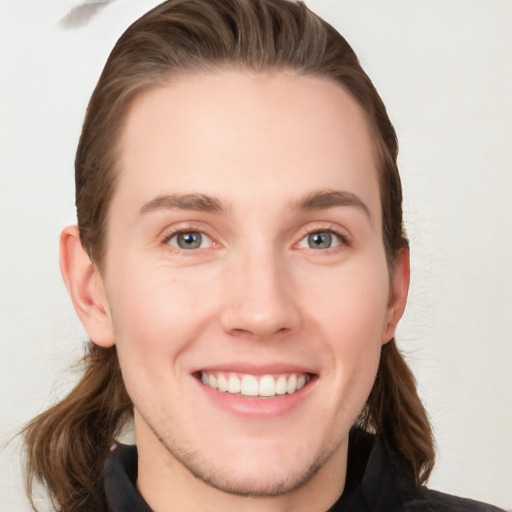 Joyful white young-adult female with long  brown hair and blue eyes