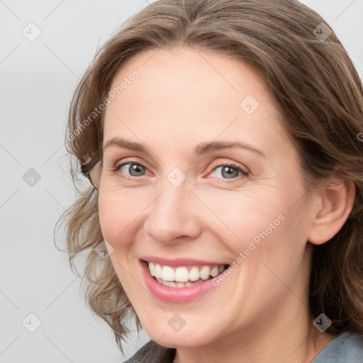 Joyful white young-adult female with medium  brown hair and blue eyes