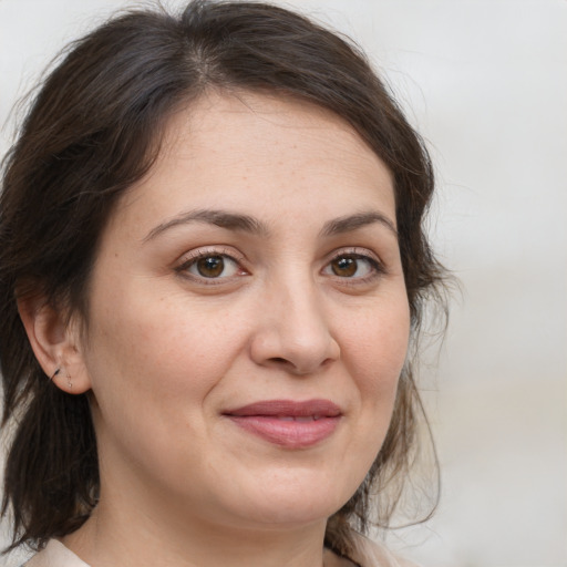 Joyful white adult female with medium  brown hair and brown eyes