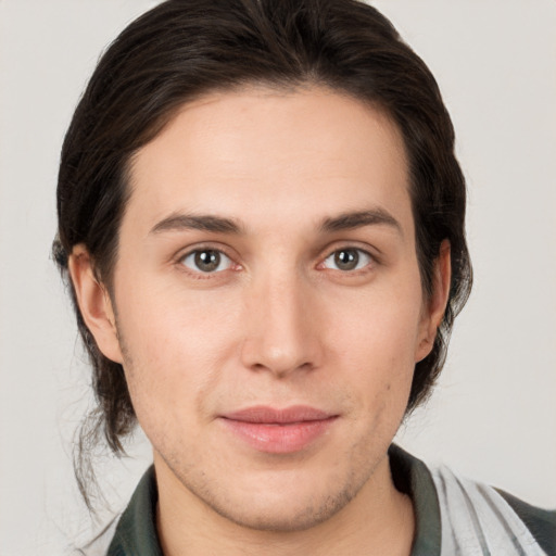 Joyful white young-adult male with medium  brown hair and brown eyes