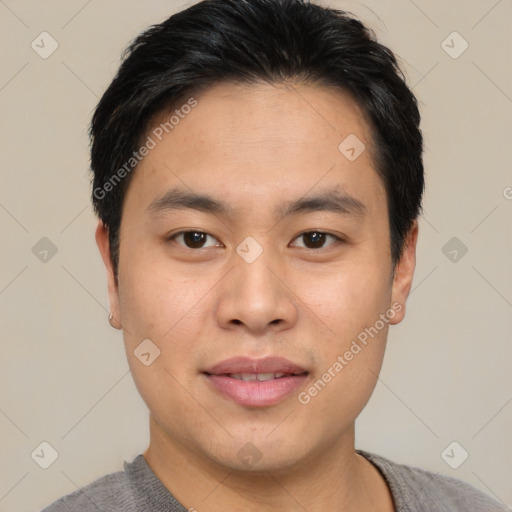 Joyful asian young-adult male with short  black hair and brown eyes