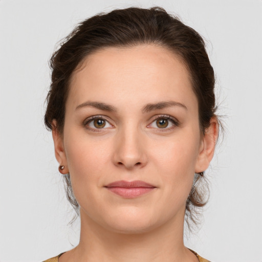 Joyful white young-adult female with medium  brown hair and grey eyes