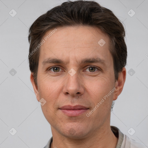 Joyful white adult male with short  brown hair and grey eyes