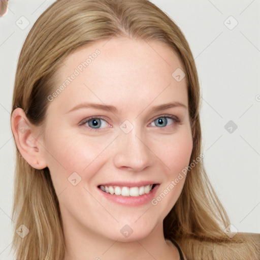 Joyful white young-adult female with long  brown hair and blue eyes