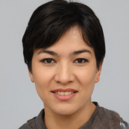 Joyful asian young-adult female with short  black hair and brown eyes