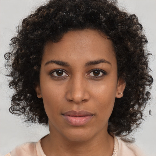 Neutral black young-adult female with medium  brown hair and brown eyes