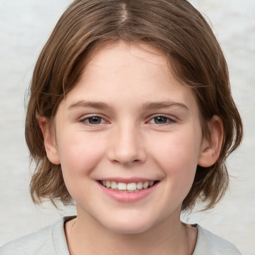 Joyful white child female with medium  brown hair and brown eyes