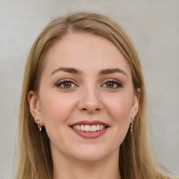 Joyful white young-adult female with long  brown hair and green eyes