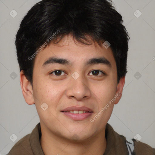 Joyful asian young-adult male with short  brown hair and brown eyes