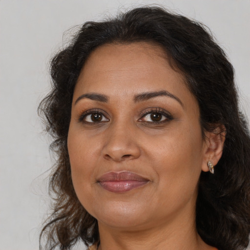 Joyful black adult female with medium  brown hair and brown eyes