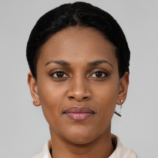 Joyful latino young-adult female with short  black hair and brown eyes
