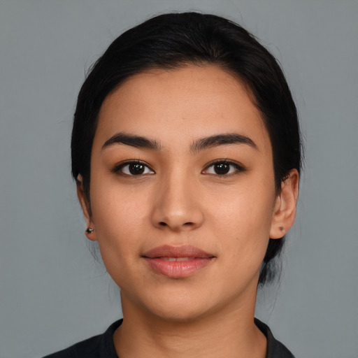 Joyful latino young-adult female with medium  black hair and brown eyes