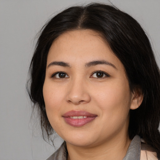Joyful asian young-adult female with medium  brown hair and brown eyes