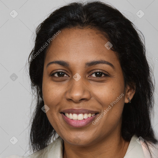 Joyful black young-adult female with long  brown hair and brown eyes