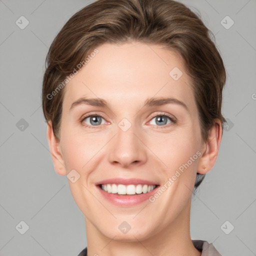 Joyful white young-adult female with short  brown hair and grey eyes