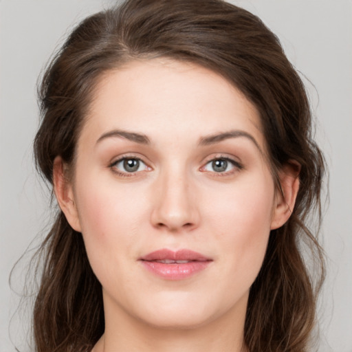 Joyful white young-adult female with medium  brown hair and green eyes