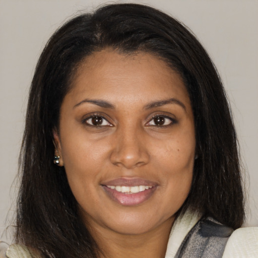 Joyful latino young-adult female with medium  brown hair and brown eyes