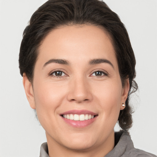 Joyful white young-adult female with medium  brown hair and brown eyes