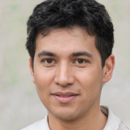 Joyful white young-adult male with short  black hair and brown eyes