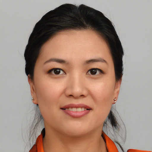 Joyful asian young-adult female with medium  brown hair and brown eyes