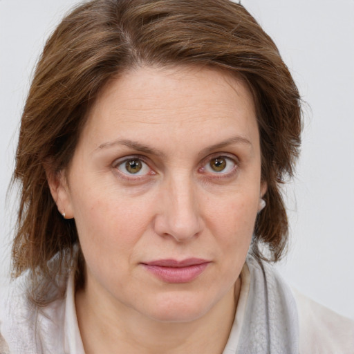 Joyful white adult female with medium  brown hair and blue eyes