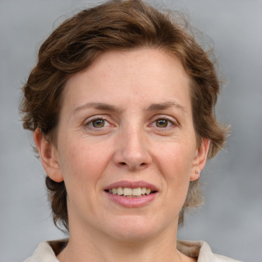 Joyful white adult female with medium  brown hair and grey eyes