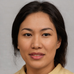 Joyful asian young-adult female with medium  brown hair and brown eyes