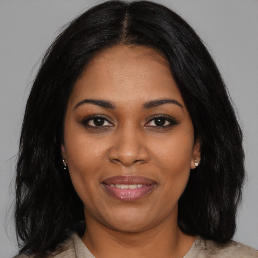 Joyful black young-adult female with medium  black hair and brown eyes