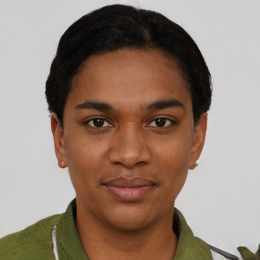 Joyful black young-adult female with short  black hair and brown eyes