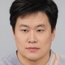 Neutral asian young-adult male with short  brown hair and brown eyes