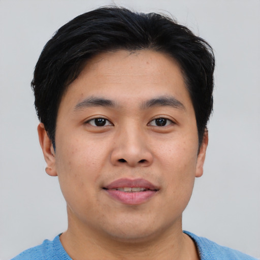 Joyful asian young-adult male with short  black hair and brown eyes